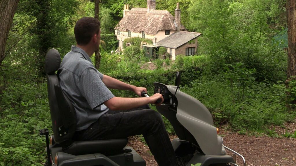 Tramper user looks at Hardy's Birthplace from path in Thorncombe Woods.